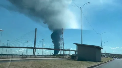 A fire consumes a tire storage facility in a neighboring port of Asunción, Asunc Stock Footage 301408076