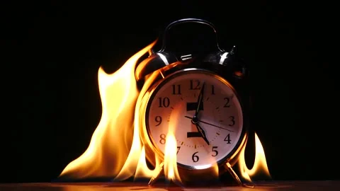 Fire consuming alarm clock in slow motion flames yellow isolated on black Stock Footage 231745955