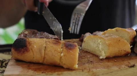 Fire Cooked Bread Roll on the Chopping Block Stock-Footage 42683725