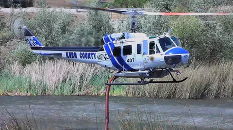 FIRE COPTER TAKES ON WATER Stock Footage 22997643