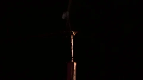 Fire cracker burning and exploding in slow motion against black background Stock Footage 81310980