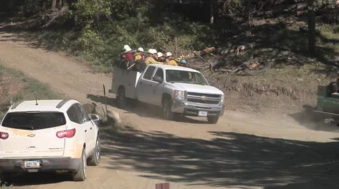 Fire crew loaded in pickup truck driving by mountain road Stock Footage 40952386
