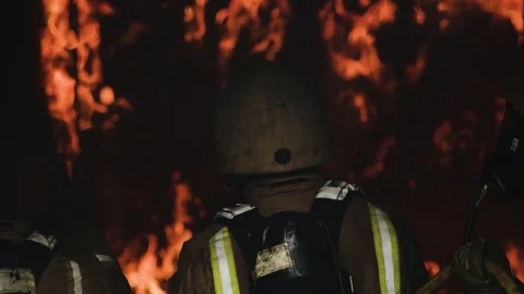 Fire crew looking into fire Stock Footage 91036682