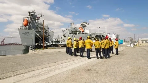 Fire crews talking on dock Stock Footage 116493271