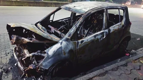 Fire damaged car sits on the edge of street Stock Footage 302633703