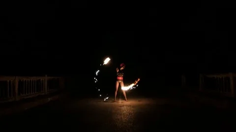 The fire dance show at a party held by the sea. women and men play fire show Stock Footage 71546765