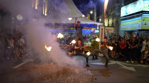 Fire dancer controls flaming torches in stunning display with fire crackers Stock-Footage 317006575