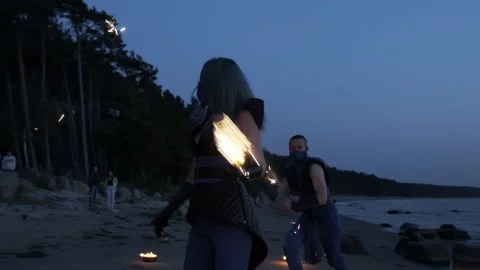 Fire dancer keeping balance of fire torch; fire show tricks Stock Footage 144675087