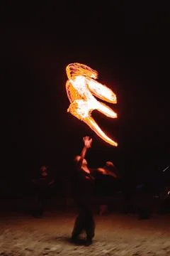 A fire dancer moves balls with ignited fired creating patterns in a long ex.. Stock Photos