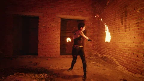 Fire dancer performing with burning poi in abandoned building Video stock 311329413