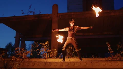 Fire dancer performing at dusk in abandoned building Video stock 311328947