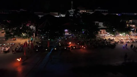 Fire dancer performing at night on a crowded beach in gili trawangan Video stock 305370648