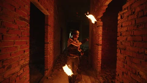 Fire dancer performing with torches in abandoned building Video stock 301875288