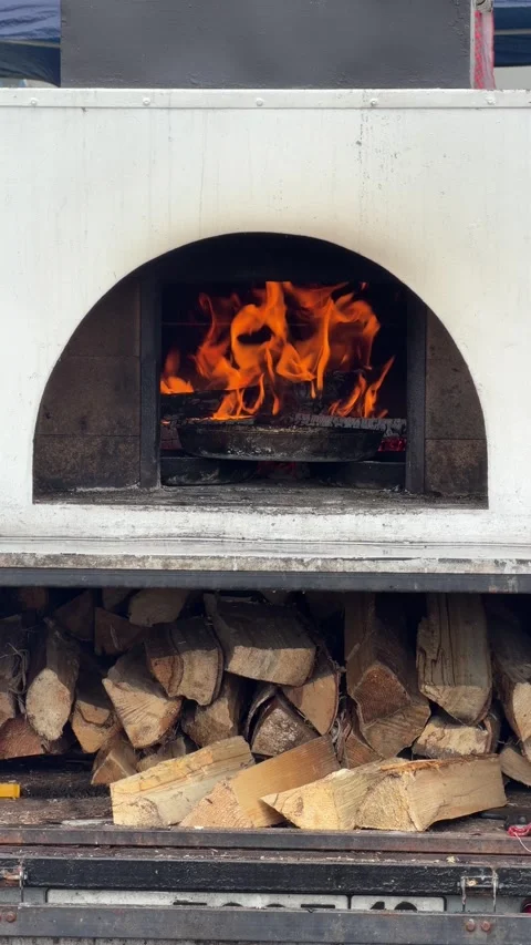 Fire dances inside white stone oven Stock Footage 345238192