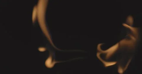 Fire dancing against dark background 120fps slow motion loopable footage Foto stock