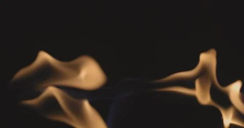 Fire dancing against dark background 120fps slow motion loopable footage Foto stock