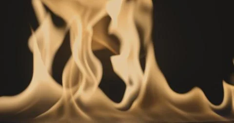 Fire dancing against dark background 120fps slow motion loopable footage Foto stock