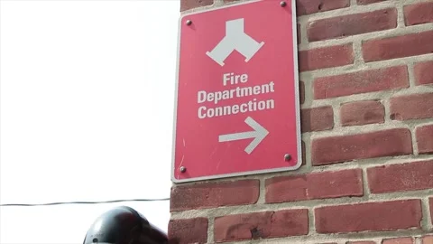 Fire department connection caption writing text sign on red brick wall Stock Footage 247144892
