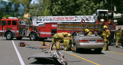 Fire department firefighters help trapped victims of car accident in LA, 4K Stock Footage 101245201
