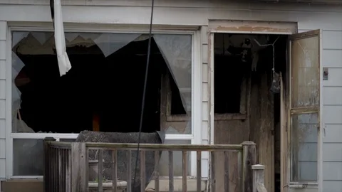 Fire destroyed house with broken windows and burnt out roof. Close up aftermath  Stock-Footage 128333817