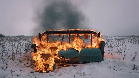 Fire destroyed the sofa. The sofa burns in the winter field Stock Footage 119523975