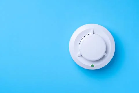 Fire detector on a blue background. Copy-space Stock Photos