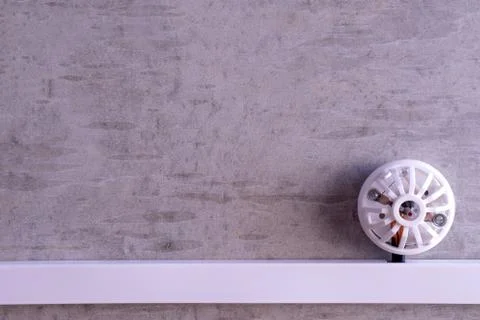 Fire detector installed on a concrete wall Stock Photos
