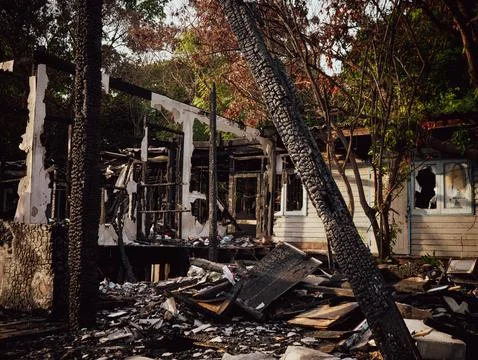 Fire disaster aftermath exterior view of burned destroyed residential house.. 스톡 사진