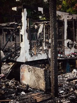 Fire disaster aftermath scene showing burned destroyed house interior with .. Foto stock