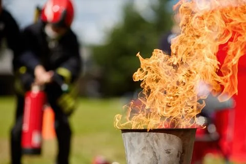 Fire Drill Training. Firefighters practice controlling an outdoor fire with Stock Photos
