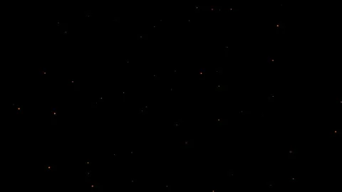 Fire dust from a fire flies through the air. Small fire particles in space Video stock 320631444