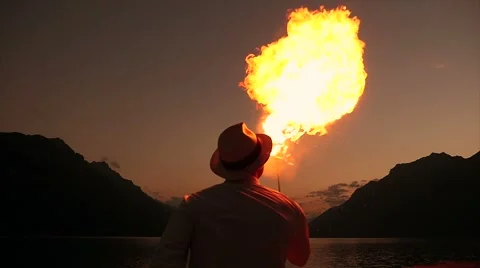Fire eater. artist presenting show with torchlight flame at night sky Stock Footage 42941570