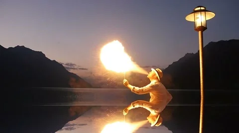 Fire eater performing fire spotting show outdoors at night Stock Footage 42942208