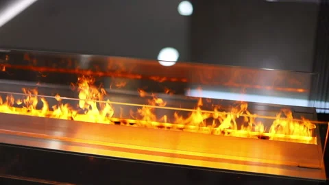 The fire in the electric fireplace is burning behind the glass Stock Footage 140747675