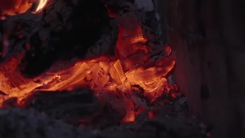 Fire embers glowing in a dark setting showcasing heat and light Stock Footage 329964820
