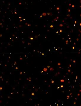 Fire embers particles over black background. Fire sparks background. Abstra.. Stock Photos