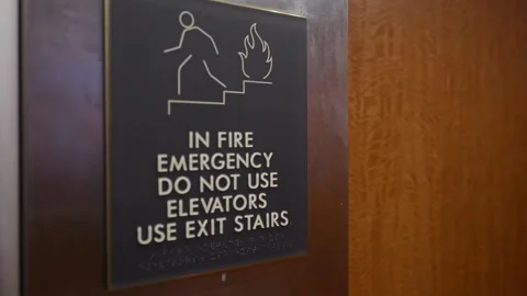 Fire emergency elevator safety sign mounted Stock Footage 346298634