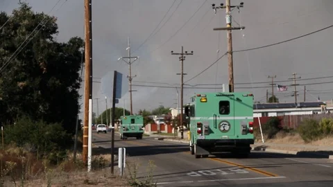 Fire emergency vehicles head towards smoke Stock Footage 114413533