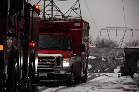 Fire engine and ambulance responding to emergency on snowy day Stock Photos