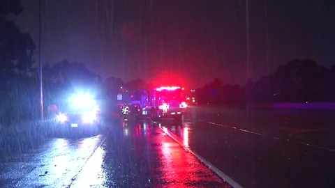 Fire engine blocks freeway in the rain Stock Footage 236333864