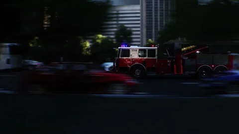 An fire engine, fire rescue driving fast on a city street. Stock Footage 328543749