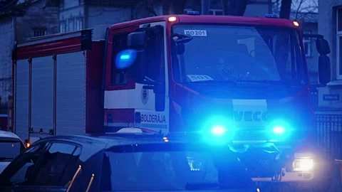 Fire Engine With Flashing Blue Emergency Lights on Urban Street in Riga, Latvia Stock Footage 346865328