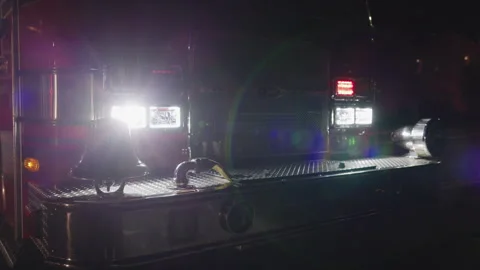 Fire Engine Front With Bell and Bright Headlights at Night Vídeo Stock 343883105