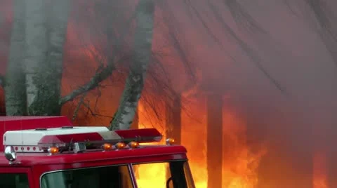 Fire engine in front of building on fire - orange flames Stock Footage 12547561
