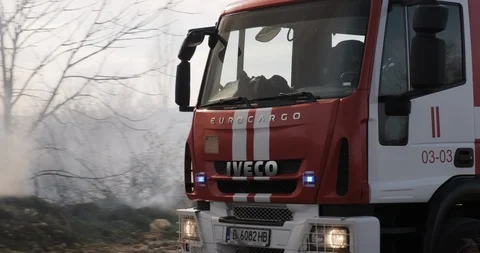 Fire engine hurries scene fire. Thick smoke, fire city park blue sky Stock Footage 127189871