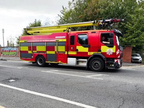 Fire engine from Manchester fire service on street with ladder extended, re.. Stock Photos