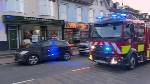 Fire engine of the North Wales Fire and Rescue Service with blue lights flashing Stock Footage 347682412
