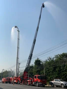 Fire engine shoot water high in the air to cut some of the toxic haze Stock Photos