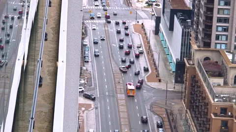 Fire engine splits urban traffic below tall apartment buildings, aerial Stock Footage 348778080