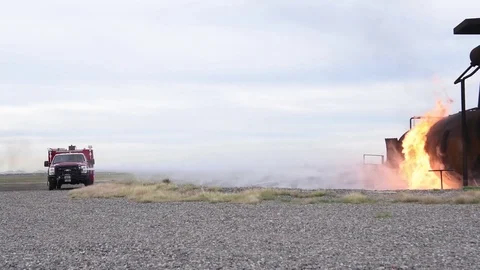 Fire engine spraying flames with water hose during fire training exercise Video stock 98933682